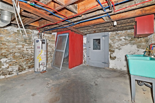 unfinished basement with water heater and a sink