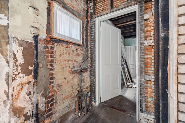 interior space featuring brick wall