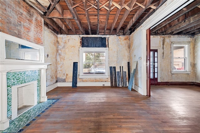 unfurnished living room with wood finished floors and baseboards