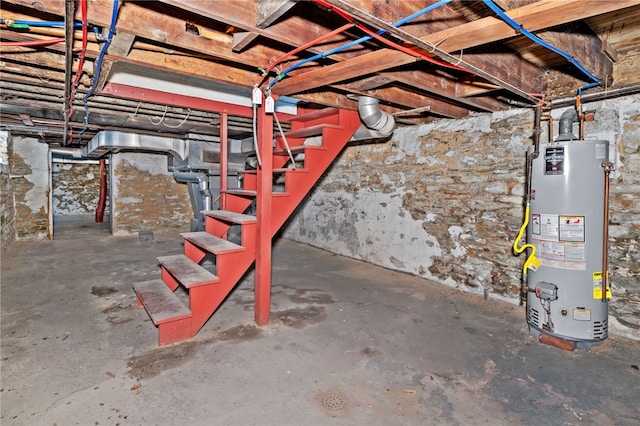 unfinished below grade area featuring stairway and water heater