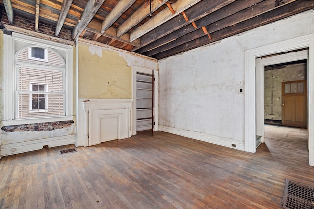 basement with visible vents and hardwood / wood-style floors