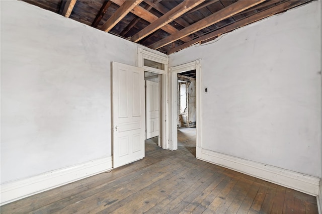 unfurnished bedroom with dark wood-type flooring