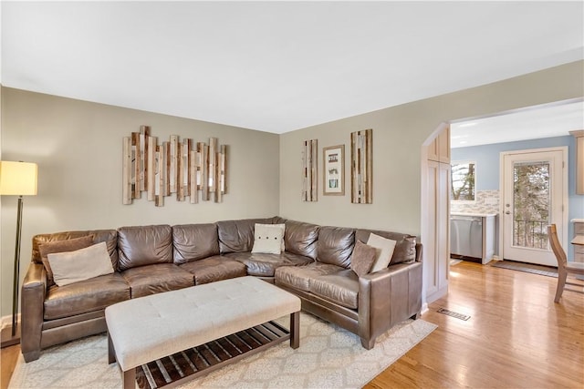 living room featuring visible vents and light wood-style floors