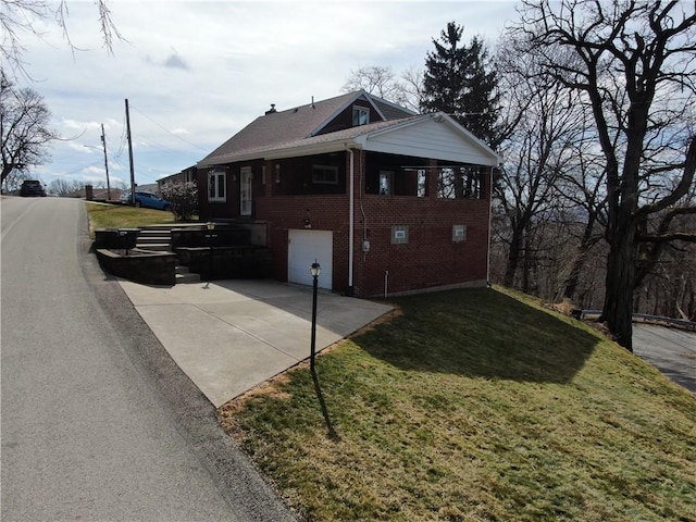 view of property exterior with concrete driveway, a yard, and brick siding