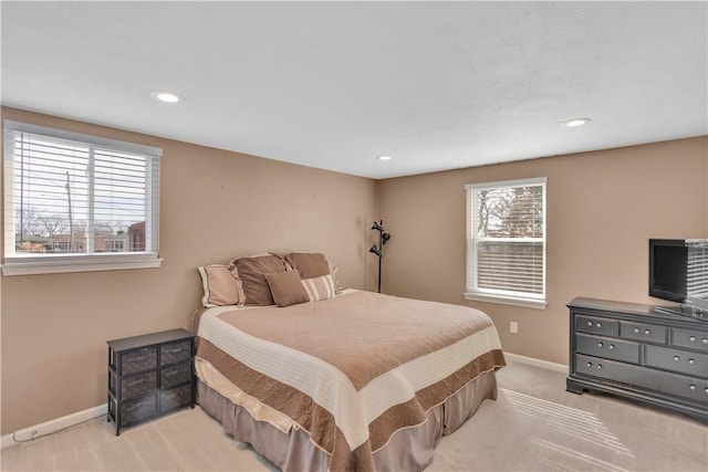 bedroom featuring light carpet, baseboards, and recessed lighting