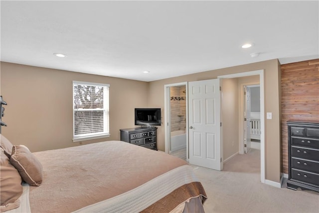 bedroom featuring baseboards, recessed lighting, ensuite bathroom, and light colored carpet