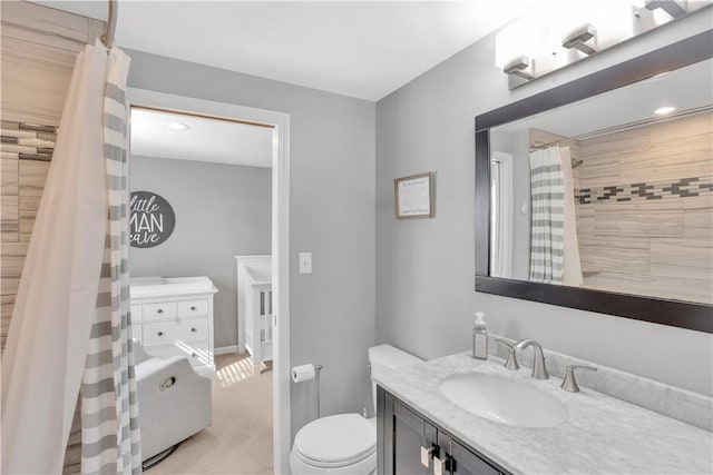 bathroom with toilet, curtained shower, and vanity