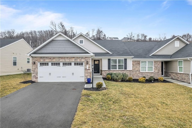 craftsman inspired home with a garage, stone siding, aphalt driveway, and a front yard