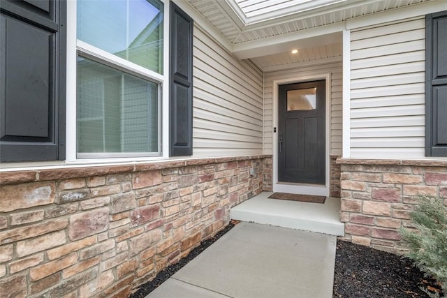 doorway to property with stone siding