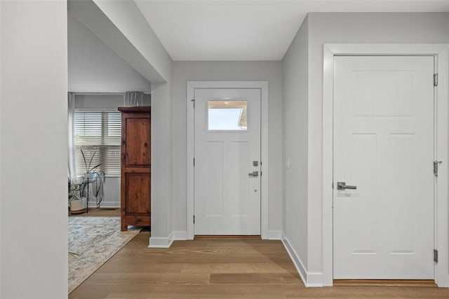 entrance foyer with light wood-type flooring and baseboards