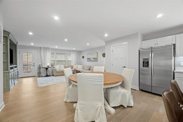 dining area featuring light wood-style flooring and recessed lighting