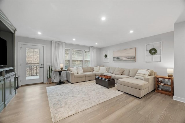 living room featuring light wood-style floors, recessed lighting, and baseboards