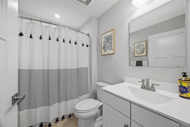 full bathroom featuring toilet, vanity, and tile patterned floors