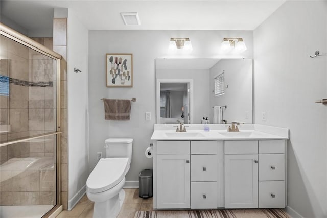 bathroom featuring visible vents, a sink, a shower stall, and toilet