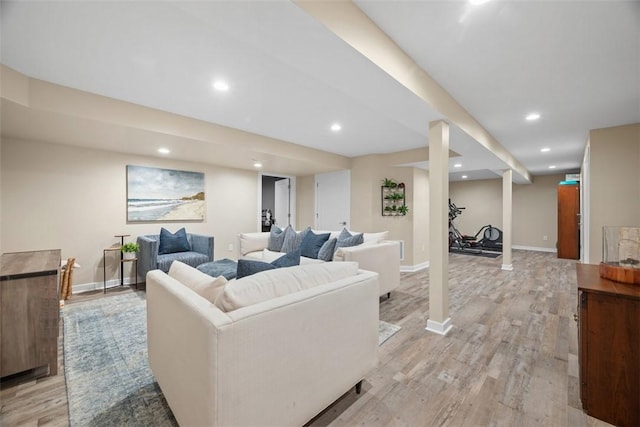 living area with light wood-type flooring, baseboards, and recessed lighting