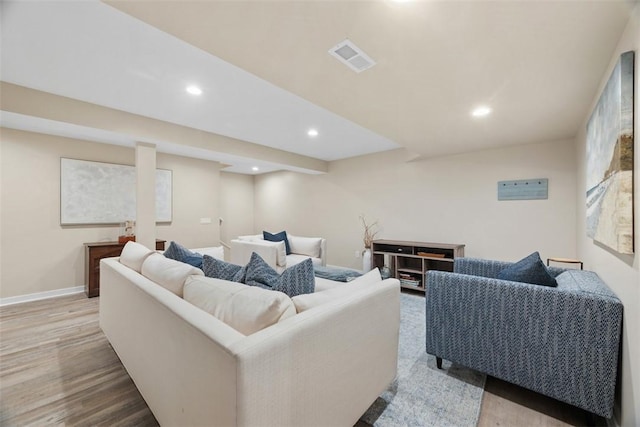 living area featuring recessed lighting, visible vents, baseboards, and wood finished floors