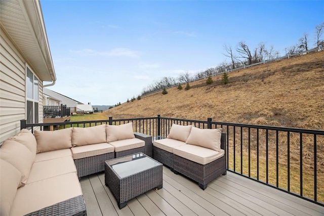 wooden terrace featuring outdoor lounge area