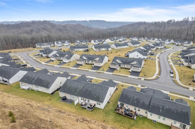 birds eye view of property featuring a residential view and a wooded view