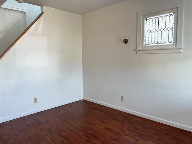 empty room with baseboards and wood finished floors