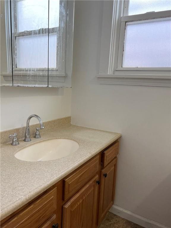 bathroom featuring vanity and baseboards