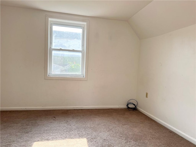 bonus room with carpet floors, vaulted ceiling, and baseboards