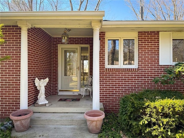 property entrance featuring brick siding