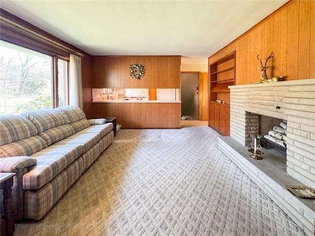720 Dogwood Ln, Hermitage, PA 16148 - living area with built in shelves, light colored carpet, wood walls, and a fireplace