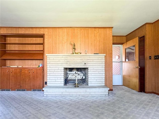 720 Dogwood Ln, Hermitage, PA 16148 - unfurnished living room with carpet floors, a brick fireplace, wooden walls, and ornamental molding