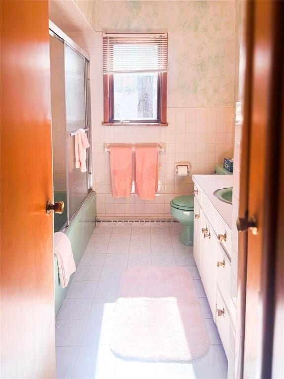 720 Dogwood Ln, Hermitage, PA 16148 - full bathroom with toilet, shower / bath combination with glass door, tile patterned flooring, vanity, and tile walls