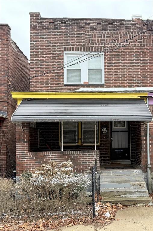 view of front of house featuring brick siding