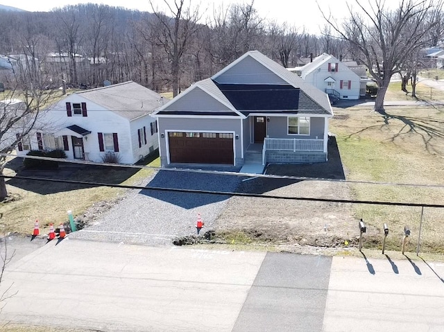 view of front of property featuring a garage, driveway, and a porch