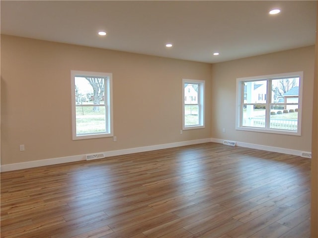 unfurnished room with plenty of natural light, visible vents, and recessed lighting