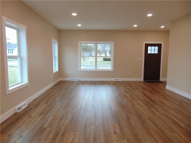 entrance foyer featuring recessed lighting, visible vents, plenty of natural light, and wood finished floors