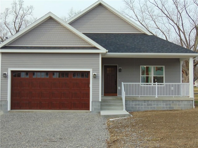 view of front facade with a garage, covered porch, roof with shingles, and driveway