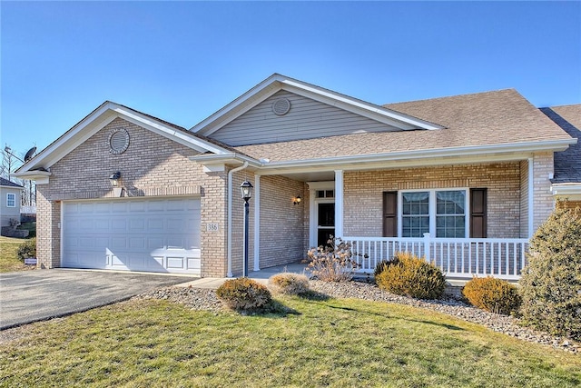 ranch-style house with aphalt driveway, an attached garage, covered porch, brick siding, and a front lawn