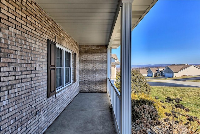 balcony featuring covered porch and a residential view