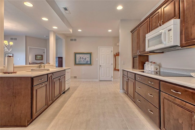 kitchen with white microwave, visible vents, light countertops, and recessed lighting