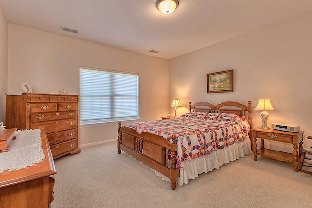 carpeted bedroom with visible vents and baseboards