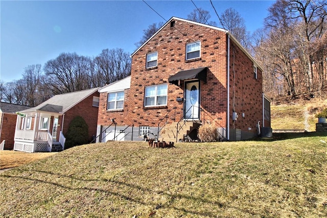 view of front of house with a garage, brick siding, a front lawn, and central AC unit