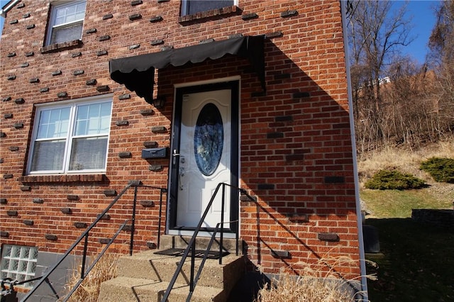 entrance to property with brick siding