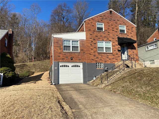 view of front facade with brick siding, an attached garage, and aphalt driveway