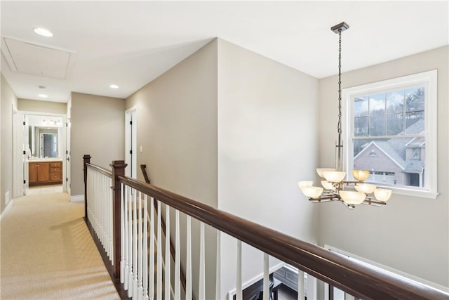 hall with recessed lighting, baseboards, light colored carpet, and an upstairs landing