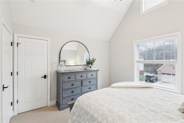 bedroom with lofted ceiling and light carpet