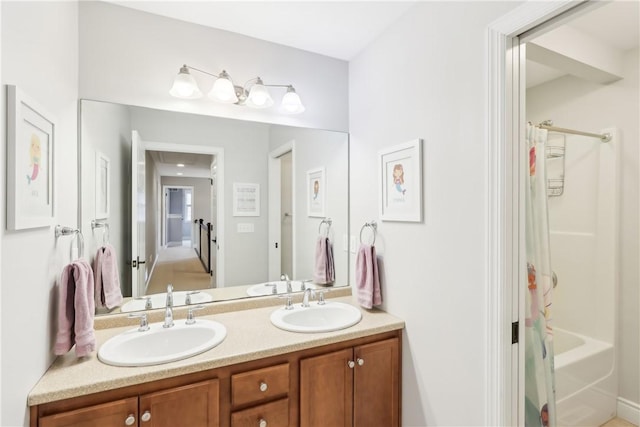 full bath featuring shower / bath combo with shower curtain, a sink, and double vanity