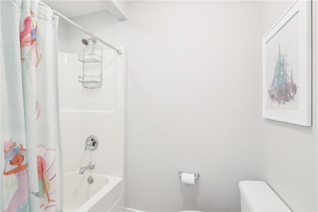 bathroom with toilet and shower / bath combo with shower curtain