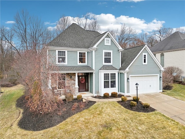 traditional home with driveway, a porch, a front yard, and a shingled roof