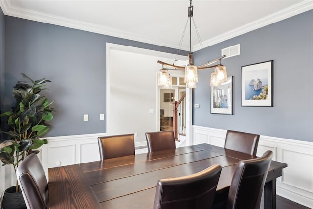 dining area with visible vents, stairs, wainscoting, dark wood-style floors, and crown molding