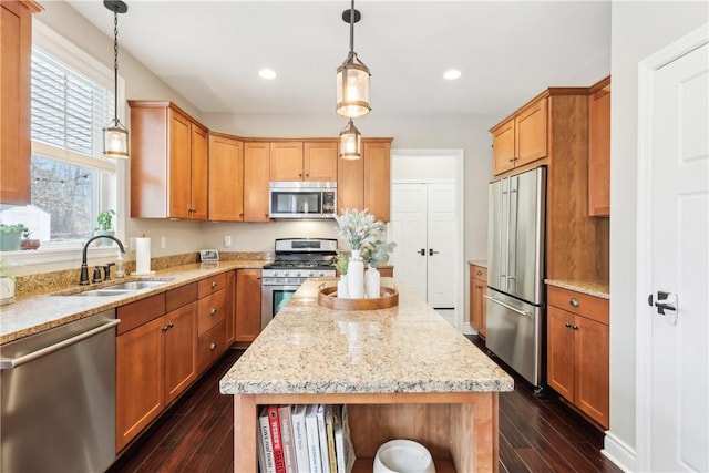 kitchen with appliances with stainless steel finishes, recessed lighting, dark wood-type flooring, and a sink