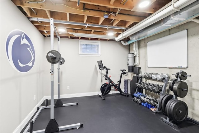 workout room featuring baseboards