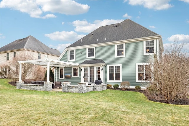 back of property with a shingled roof, a yard, a patio, and a pergola